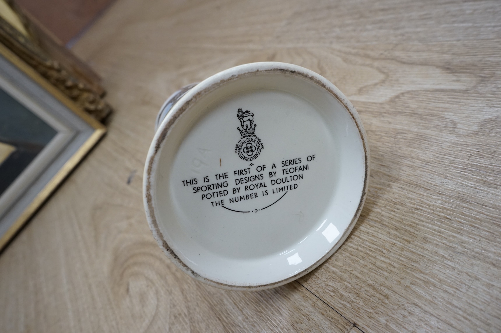 A quantity of plated cutlery, a Royal Doulton limited series sporting mug by Teofani and an Aynsley plate, 27.5cm diameter.